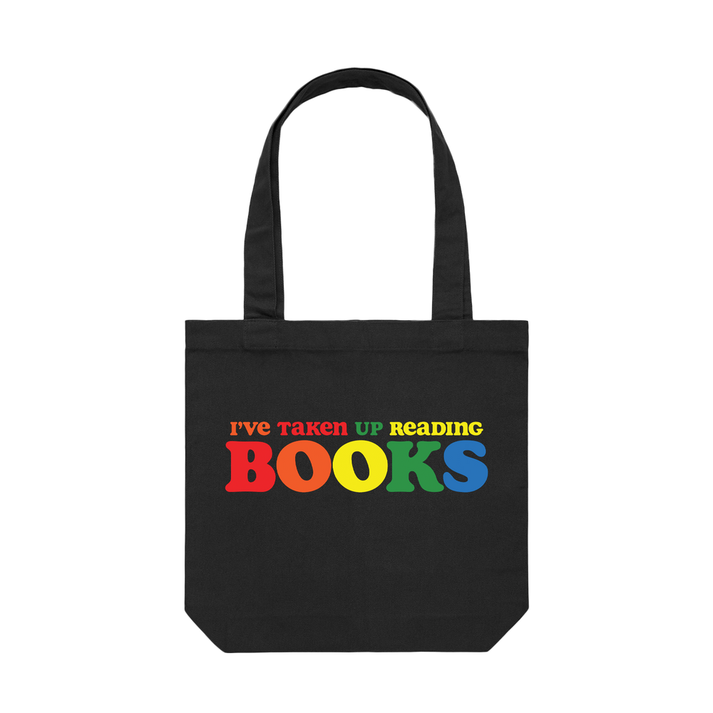Black tote bag with the phrase "I've taken up reading books" printed in multiple colors on the front