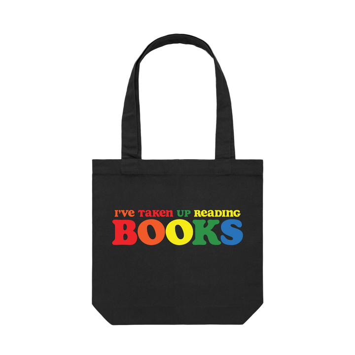 Black tote bag with the phrase "I've taken up reading books" printed in multiple colors on the front
